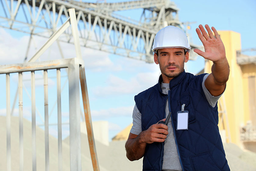 Worker on a construction site waving his hand